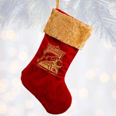 a red christmas stocking hanging from a tree