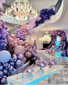 a room filled with lots of balloons and tables