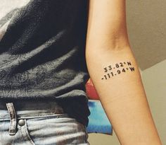 a woman with a tattoo on her arm that says, we are all in the wrong place