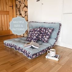 a chair that is sitting on the floor next to a book and cup with coffee in it