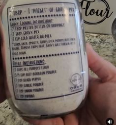 a hand holding a jar with instructions on it