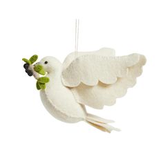 a white bird ornament with green leaves on it's beak and wings