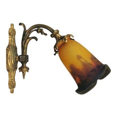 an old fashioned wall light with a glass shade