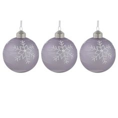 three glass ornaments with snowflakes on them