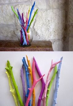 two different colored sticks in a vase on a shelf next to another one with the same color sticks sticking out of it