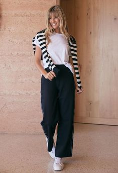 DESCRIPTION Step into the Luxe Straight Leg Ponti Pant, another wardrobe staple by White & Co. These flattering pants boast a modern edge with a sleek, French-inspired black and white stripe tape down the sides. Perfect for the office or weekend outings, they pair beautifully with a crisp white tee and classic blazer for a monochromatic look, or add a pop of colour with a patterned blouse for an effortless transition from day to night. Elevate your casual look by pairing these pants with the Montreal turtleneck and a pair of loafers or create a weekend-ready outfit with a denim jacket and sneakers. Still browsing? Discover our full range of women's clothing. FEATURES & FIT Relaxed straight-leg cut Easy pull on design Elasticated waist Black and white trim tape detailing down the side Side Black And White Striped Pants Outfit, Striped Tee Outfit, White Striped Pants Outfit, Stripe Tee Outfit, 2024 Photoshoot, Black And White Striped Pants, Flattering Pants, Patterned Blouse, Photoshoot Inspo