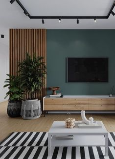 a living room with green walls and black and white striped rugs on the floor