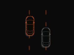 an overhead view of two cars in the dark