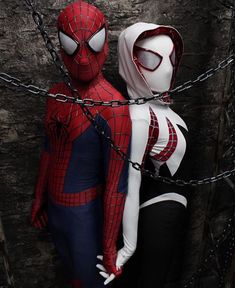 two spider - man cosplay standing next to each other