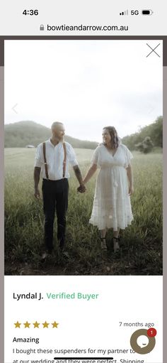 a man and woman standing next to each other holding hands in front of a field