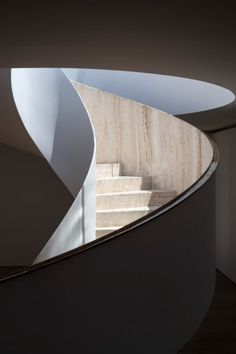 a spiral staircase in a building with white walls