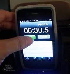 a hand is pressing the time on an iphone