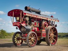 an old fashioned fire engine sitting in the dirt