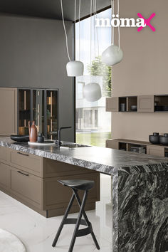 a modern kitchen with marble counter tops and bar stools