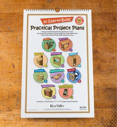 an easy - to - build practical project plans book on a wooden table with clippings