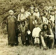 an old black and white photo of native american people in the wild with long braids