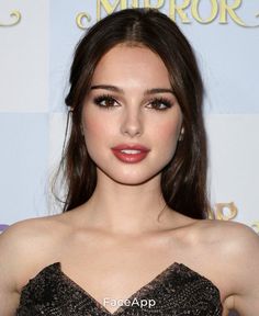 an image of a woman with long hair wearing a strapless dress and red lipstick