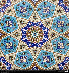 an intricate tile design in blue and brown colors with flowers on it's surface