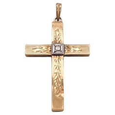 This intricately engraved cross is perfect for the person whose many intricacies you appreciate! A round diamond sits at the center of the cross, shining as bright as the spirit of your recipient, set in white gold and weighing 0.02 carats. This is a beautiful estate piece, ready to be loved again, just as we all deserve to be loved every day. This cross is a great gift to honor commitments, celebrate religious milestones, or remind someone special that they are loved, no matter what. This pendant is made out of 14 karat yellow gold and white gold (stamped "14K"). The cross measures 1 inch long by 3/4 inch wide, and the complete pendant measures just over 1.25 inch long. The details for this intricate cross pendant are listed below: Metal Quality: 14 karats Complete Weight: 1.0 grams Measu White Gold Cross Charms For Anniversary, Classic Diamond Cut Cross Necklace For Formal Occasions, Classic Formal Cross Necklace With Diamond Cut, Classic Crucifix Cross Necklace For Formal Occasions, Engraved White Gold Cross Necklace, Engraved Cross Necklace For Anniversary, Elegant Memorial Cross Jewelry, Elegant Cross Jewelry For Memorial, Diamond Cut Crucifix Cross Necklace For Anniversary