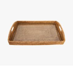 a rectangular wicker tray with handles on the bottom is shown in front of a white background