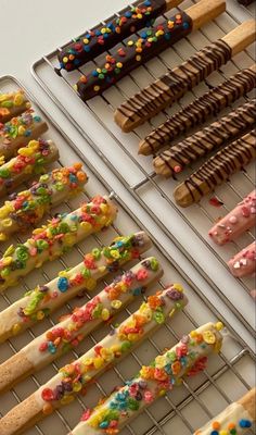 there are many different kinds of donuts on the rack and one is decorated with sprinkles