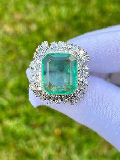 "Top-quality natural Colombian Emerald set in vintage palladium ring. Center stone is mounted in an elaborate baguette and round cut diamond halo. This vintage ring is estimated to originate circa 1950. A true one-of-a-kind, handmade ring. This ring is for those with a refined and sophisticated taste in fine vintage jewelry. Superbly clean and brilliant natural diamonds with an intricate ring setting. All culminated with an exceptional Emerald center stone of legendary provenance. Additional vid Platinum Emerald Ring In White Gold, Luxury Platinum Cluster Emerald Ring, Exquisite Platinum Emerald Ring With Brilliant Cut, Luxury Platinum Emerald Ring With Prong Setting, Exquisite Platinum Emerald Ring With Prong Setting, Luxury White Gold Emerald Ring With Rose Cut Diamonds, Heirloom Emerald Ring With 17 Jewels In Platinum, Heirloom Platinum Emerald Ring With 17 Jewels, Dazzling Emerald Ring In White Gold And Platinum