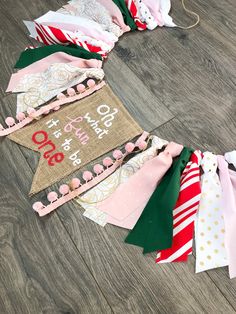 a number of different types of ties on a wooden floor next to a sign that says it's christmas