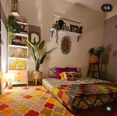 a room with a bed, rug and shelves on the wall above it is decorated with potted plants