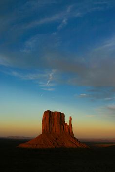 the sun is setting over monument rock in monument national park