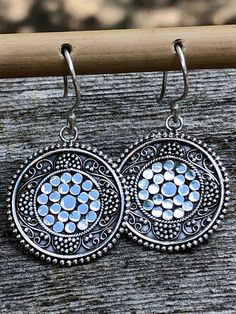 Round Silver Earrings Circle Granulation,Boho Ethnic Earrings Solid Sterling Silver Dangle Intricate Detail,Ancient Design Modern Tribal 925 These Round Silver Earrings Circle Granulation are Boho Ethnic Earrings Solid Sterling Silver Dangle Intricate Detail and Ancient Design Modern Tribal 925 Style Earrings. Truly original and hand done with intricate granulation, these Earrings can fit into many styles and span many fashions. These are classic and very eye catching and beautifully detailed. To achieve this design, each ball of Sterling Silver is applied one at a time, which is called granulation. This is a very time consuming technique all done by hand. These Sterling Silver Earrings are bright silver and 'pop' because of the patina in between each ball of Silver was applied.   The flat Silver Spiritual Plug Earrings For Festivals, Spiritual Sterling Silver Earrings For Festivals, Spiritual Silver Plug Earrings For Festival, Bohemian Sterling Silver Earrings For Festival, Silver Spiritual Earrings For Festivals, Bohemian Sterling Silver Oxidized Plug Earrings, Bohemian Sterling Silver Earrings With Oxidized Finish, Silver Plug Earrings With Oxidized Finish For Festival, Silver Bohemian Earrings For Festivals