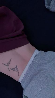 a woman's stomach with two birds on it