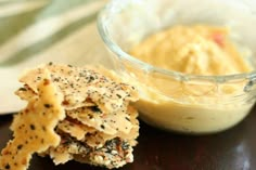 crackers and dip in a glass bowl on a table