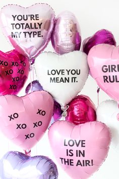 pink and white heart shaped balloons that say you're totally my type, love you mean it