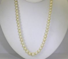 This is an antique 18 inch long pearl necklace with a 10K white gold filigree safety clasp. The necklace consists of sixty-nine (69) round, beautifully matched, cream color, genuine cultured pearls graduating from 5 MM to 8.7 MM with low luster and natural surface imperfections. The single strand necklace is easy to wear and beautiful when paired with a favorite suit, sweater or blouse. The necklace has been lightly cleaned, weighs 29.6 grams and the clasp is marked, tested and guaranteed 10K. It might also make a great gift for that someone special with a June birthday as that month's birthstone is the pearl. 16114 Classic Cream Pearl Chain Necklace, Formal Single Strand Cream Pearl Necklace, Formal Cream Single Strand Pearl Necklace, Cream Pearl Necklace For Formal Occasions, Formal Cream Pearl Necklace, Classic Cream Pearl Necklace, Classic Cream Necklace For Anniversary, Long Beach Ny, Suit Sweater