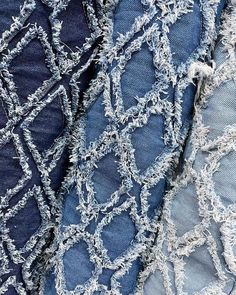 several pieces of denim fabric with holes and fraying on them, all in different colors