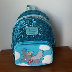 Disney Loungefly Dumbo Sequin Mini Backpack Blue One Size New Condition: New, No Flaws Or Damages. Comes With Paper Stuffing In Bag And Shipped With Plastic Over Bag In Box Features: -Fun, Unique, Collectible -Disney Dumbo Character -Dumbo Theme Interior Backpack Lining, -Blue Sequin. -Side Pockets With Full Zip Front Pocket And Main Full Zip Backpack Compartment -Back Of Backpack Has Saying “Don’t Just Fly, Soar! -Perfect For Your Next Disney Vacation -Adjustable Straps -Clean Interior And Exte Dumbo Characters, Dumbo Movie, Disney Loungefly, Disney Bag, Disney Collectables, Blue Backpack, Disney Vacation, Sequin Mini, Disney Vacations