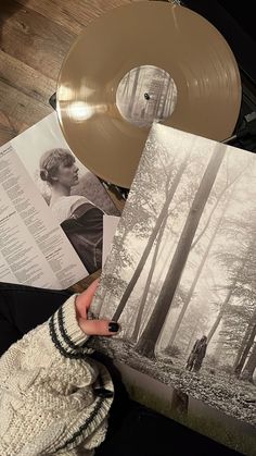 a person holding an old record in their hand