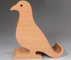 a wooden bird sitting on top of a table