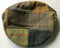 These traditional flat caps were made in County Cork, Ireland by Shandon Hats.   They are made from tweed wool and are fully lined.   They are all in the same mixture of tweeds but the placement of the patches may differ from the picture.  The brim is attached to the hat with a snap / press fastener.   See the chart for your best size.  Shandon Hat and Cap Size Measurements Size Chart Small Medium Large XL 2XL Head Size 6 7/8 7 1/8 7 1/4 7 1/2 7 3/4 Inches 22 22 3/4 23 1/4 24 24 3/4 Cm 56 58 59 61 63 Multicolor Flat Cap For Fall, Irish Flat Cap, Irish Hat, Irish Tweed, Flat Caps, County Cork, Cork Ireland, Flat Cap, Green Brown