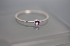 This February Birthstone ring is solid sterling silver 1mm band with a 3mm Purple Amethyst gemstone. * 1mm thick band * Silver, 14k Rose, or 14k Yellow Gold * 3mm Amethyst *Can be made in any size, 1/2 size or 1/4 size **All gold is sourced from a green certified refiner and 100% recycled gold. **All items are presented in a 100% recycled paper box with a paper raffia bow. Thank you for looking at my shop! http://www.etsy.com/shop/tinysparklestudio For rad Leather Bags go visit: https://www.etsy Tiny Silver Elegant Birthstone Ring, Dainty Stackable Amethyst Ring For Anniversary, Dainty Amethyst Birthstone Ring, Dainty Stackable Amethyst Ring Gift, Dainty Stackable Amethyst Ring As A Gift, Dainty Amethyst Birthstone Ring In Sterling Silver, Dainty Amethyst Stackable Rings For Gift, Dainty Sterling Silver Amethyst Birthstone Ring, Minimalist Amethyst Birthstone Ring For Anniversary