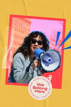 a woman holding a blue megaphone in front of a yellow background with the words we belong here on it