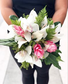 a woman holding a bouquet of flowers in her hands