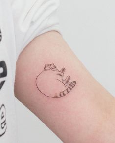 a small cat tattoo on the left arm