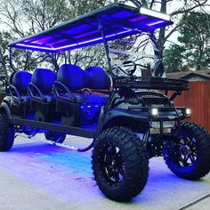 a black golf cart with blue lights on it