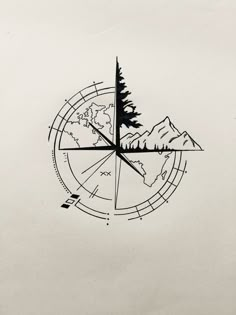 a compass with trees and mountains in the middle is drawn by hand on white paper