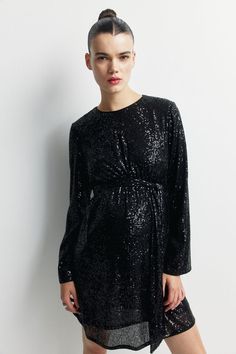 Short dress in sequined mesh. Round neckline  keyhole opening at back with a concealed button  darts at bust  and a removable tie belt below bust. Long  wide sleeves. Lined. Maternity Sequin Dress, Tie Belt Dress, Belt Tying, Wide Sleeves, Tie Belt, Belted Dress, Short Dress, Sequin Dress, Round Neckline