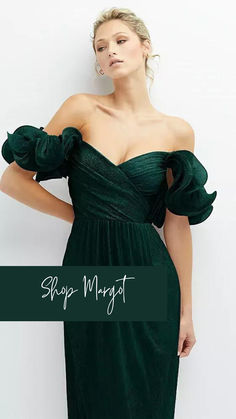 a woman wearing a green dress with ruffle sleeves and an off the shoulder top