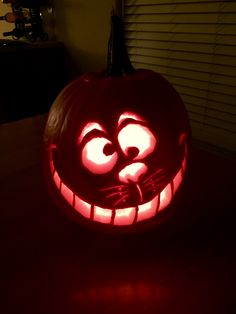 a pumpkin with the face of an angry cat carved into it's mouth and eyes