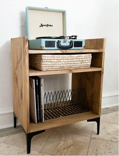 an old record player on top of a wooden shelf