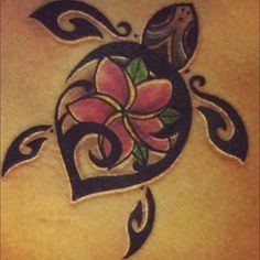 a close up of a tattoo on the back of a woman's stomach with a flower